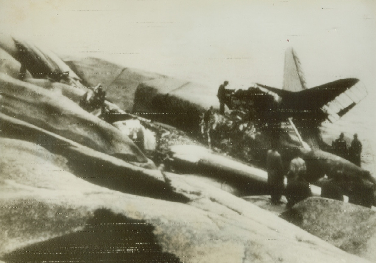 CHECK PLANE WRECKAGE, 10/27/1943. STOCKHOLM, SWEDEN—A special Swedish government commission carefully examines the wreckage of one of its airliners, the Gripen, which crashed in flames on the island of Haalloe recently. The commission is seeking to ascertain whether the plan was shot down by a German war bird. Credit: Acme;