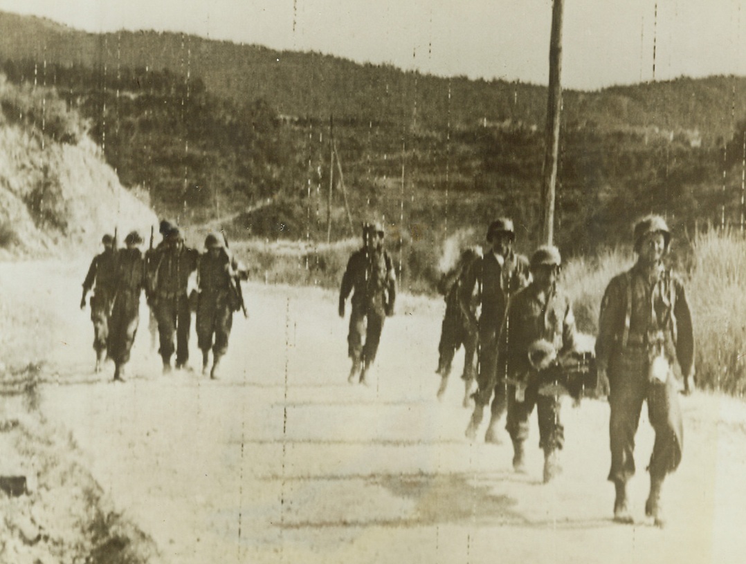 CASUALTIES OF ITALIAN CAMPAIGN, 10/2/1943. ITALY—Members of the U.S. Medical Corps assist and carry injure infantrymen on a two-mile trek to a hospital in Italy. Unavailability of ambulances seems to be the problem here. Credit: Signal Corps radiotelephoto from Acme;