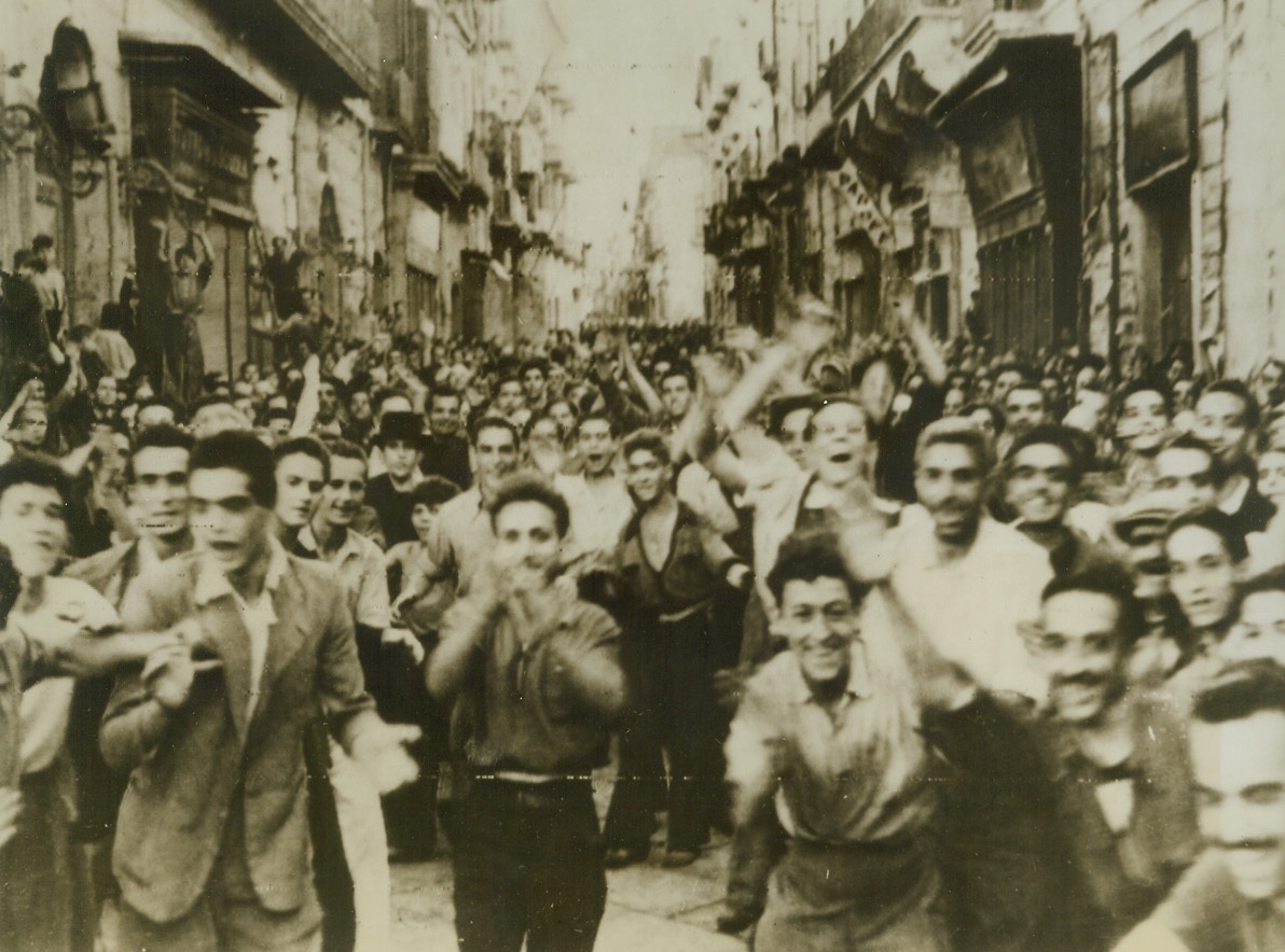 CHEER ALLIES, 10/2/1943. ITALY—This radiophoto just received tonight in New York shows cheering crowds as they greet Allied troops who are entering Torre D’Annunciata, near ancient Pompeii, on their way to Naples. Credit: OWI radiophoto from Acme;