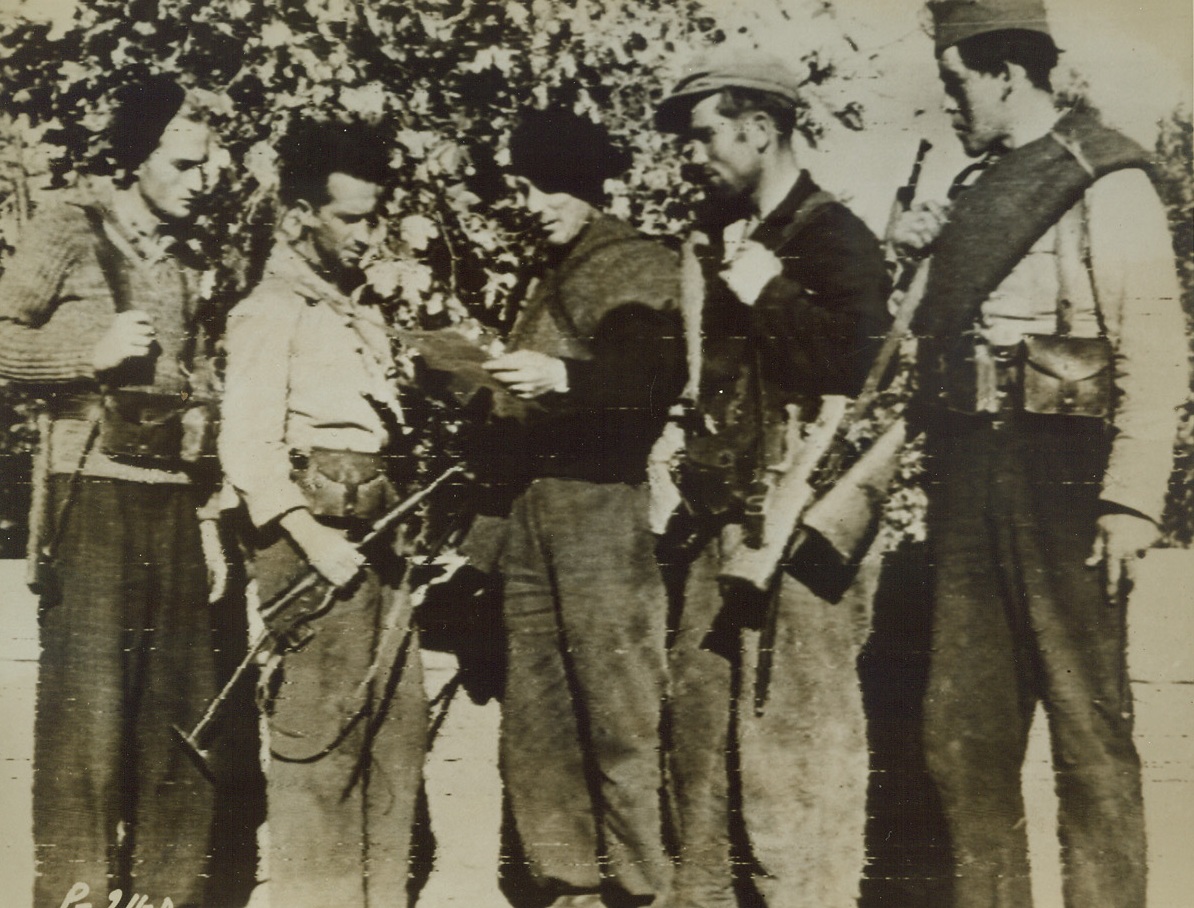 HELPED DRIVE GERMANS FROM CORSICA, 10/2/1943. WASHINGTON, D.C.—This is a group of typical French patriots who have been carrying on guerilla warfare against the Germans on the island of Corsica. They are shown discussing plans of battle. These warriors brought to the island in French ships and right under the noses of the enemy, are well trained and are well aware of the dangers that contront them. Credit: Signal Corps radiotelephoto form Acme;