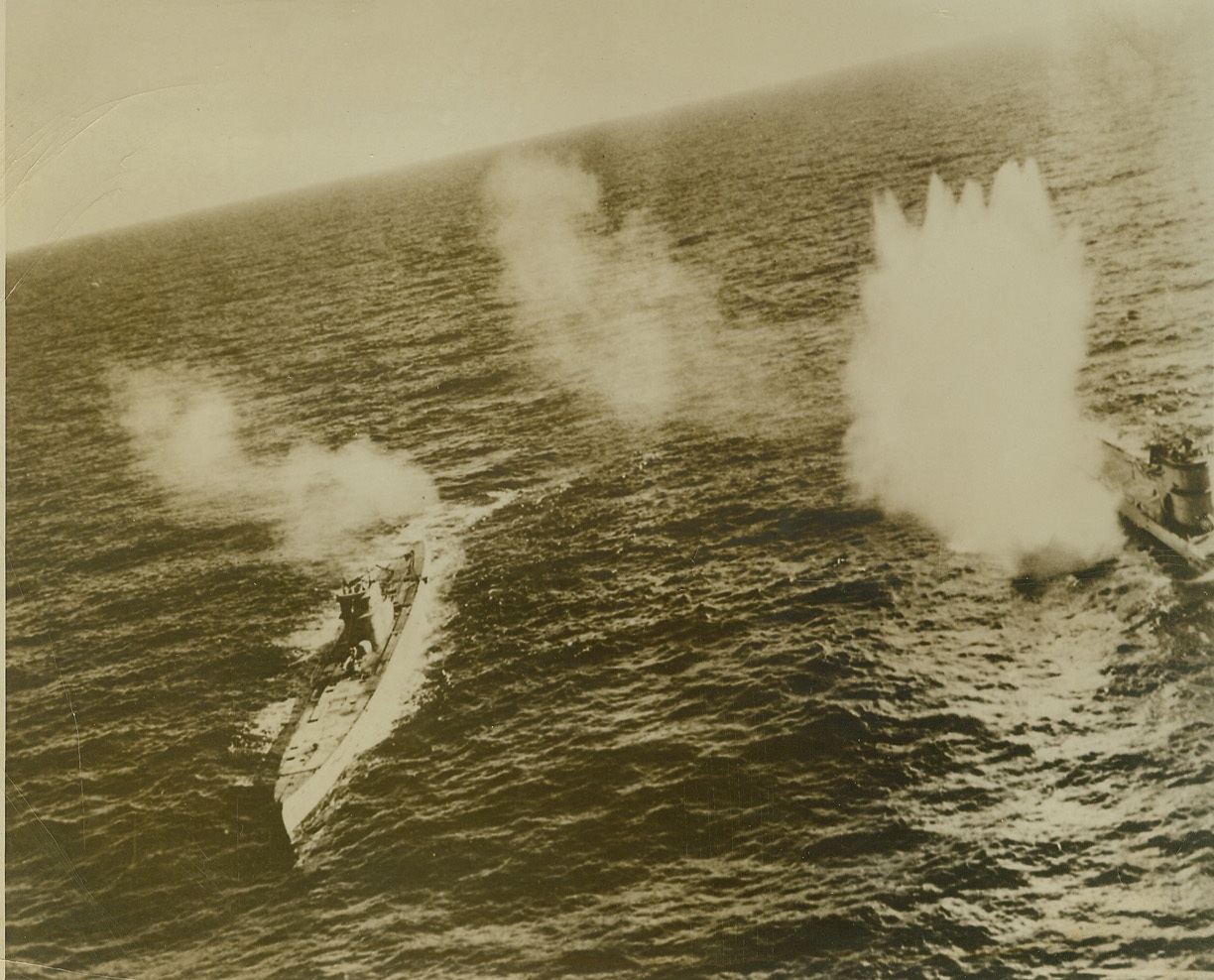 Caught in the Act, 10/22/1943. Apparently just about to attempt a refueling at sea, these two Nazi subs were surprised by depth bombs from a Grumman Avenger torpedo bomber. Attacking both subs single-handed, the pilot planted a depth charge which raises a plume of spray at right. The refueler was believed to be the U-boat at left. Credit: (Official US Navy Photo from ACME);