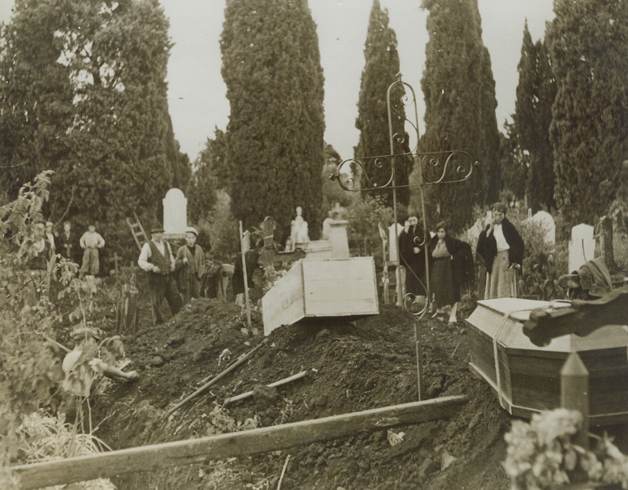 Burial for Nazi Mass Murder Victims, 10/29/1943. ITALY – Canadians spearheading the Eighth Army’s drive through Italy witnessed this burial at Rionero. Sixteen Italians were massacred by Germans when an Italian shot a German in protest against chicken-stealing. Here, the last two victims are being buried. Credit Line (ACME);