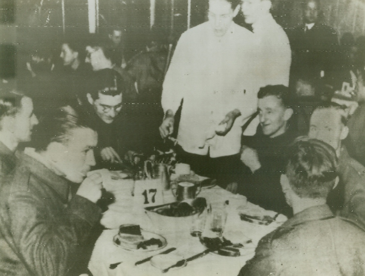 Await Exchange, 10/19/1943. GOTEBORG, SWEDEN – British, Australian and Canadian soldiers, prisoners of the Germans, have a bite to eat aboard the Swedish liner Drottningholm at Goteborg harbor before repatriation. The first exchange of prisoners of war between the Allies and Germany is being made at this Swedish port as 4,340 sick and wounded Allied soldiers, including 17 Americans, are returned to their homelands. Photo radioed from London to New York today (Oct. 19). Credit Line (ACME Radiophoto);