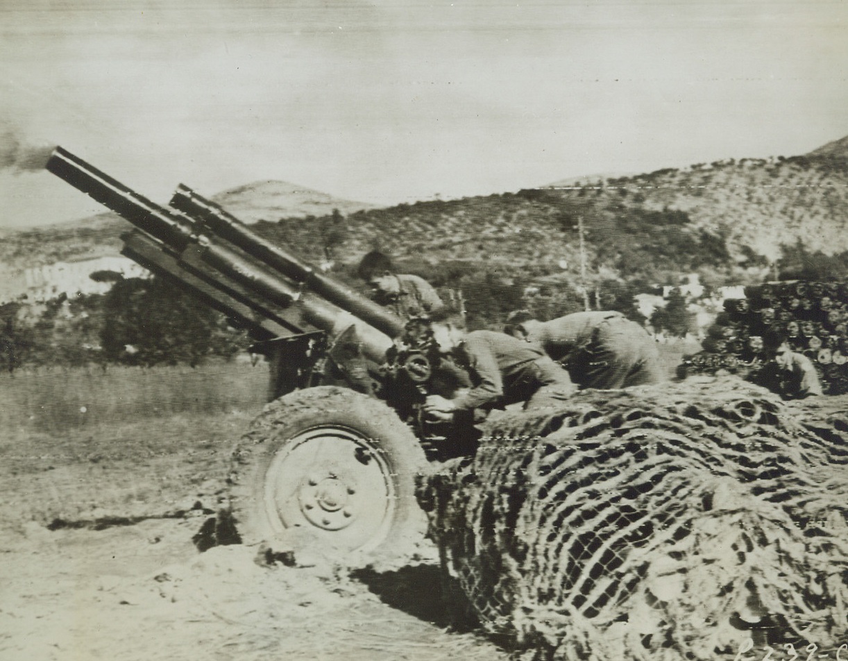 Aimed at German Machine Gun Nest, 10/16/1943. ITALY – Aimed at a German machine gun position in the Volturno River sector near Casenta, one of the American 105 MM batteries goes into action. Germans tonight acknowledged retreats north of the river and Allied Headquarters said that they are preparing new defense line along Garigliano River 80 miles south of Rome. Credit Line (Signal Corps Radiotelephoto from ACME);