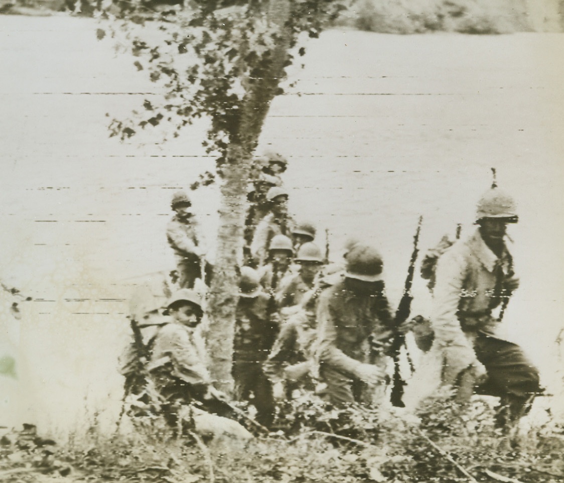 Yanks Cross Volturno, 10/19/1943. Advancing against the Germans, American troops disembark from their pontoon raft after crossing the Volturno River in Italy. This picture was taken by Bert Brandt, Acme photographer for the war picture pool, and flashed to the Untied States by Signal Corps Radiotelephoto. Credit (Acme by Bert Brandt for War Picture Pool via Signal Corps Radio-Telephoto);