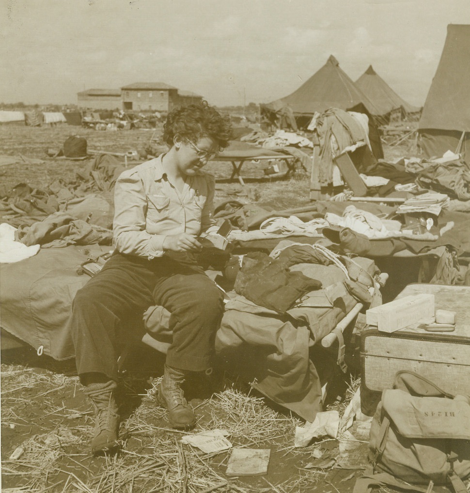 After the Storm, 10/13/1943. ITALY – The first big rainstorm experienced by our troops in Italy played havoc with the Army’s newly-established evacuation hospital. Here, after the storm, surgical nurse Edith Bishop, who hails from Green Bay, Wisc., gets her equipment in working order.Credit: – WP—(Photo by Charles Seawood, ACME Photographer for War Pool);