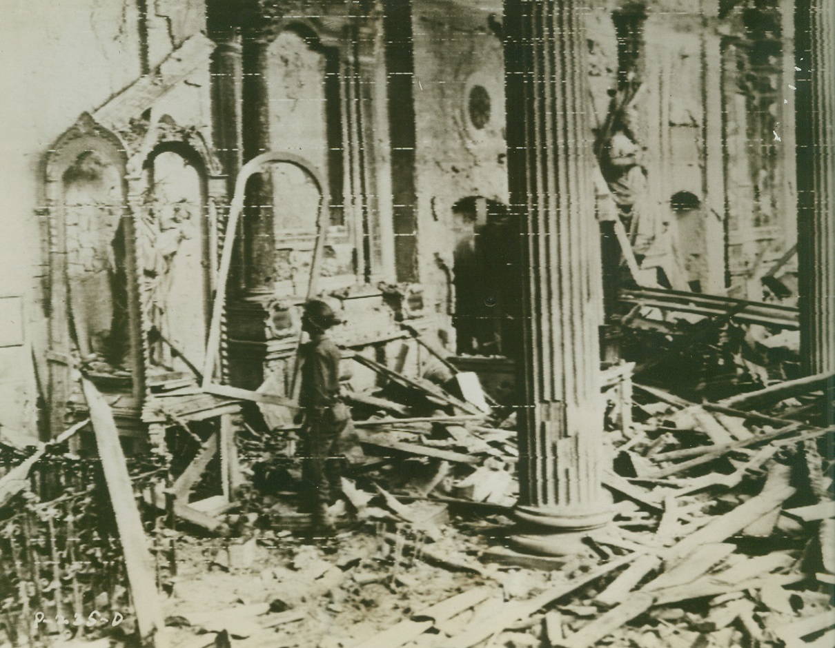 War Passes By, 10/13/1943. ITALY – Bernhard Haber, of New York City, stands wonderingly before a holy statue which was untouched by the forces of war that crippled the church in Benevento, Italy. Rubble covers the floor of the place of worship, but only the casing of the statue was shattered by demolition.Credit (U.S. Army Signal Corps Radiotelephoto from ACME);