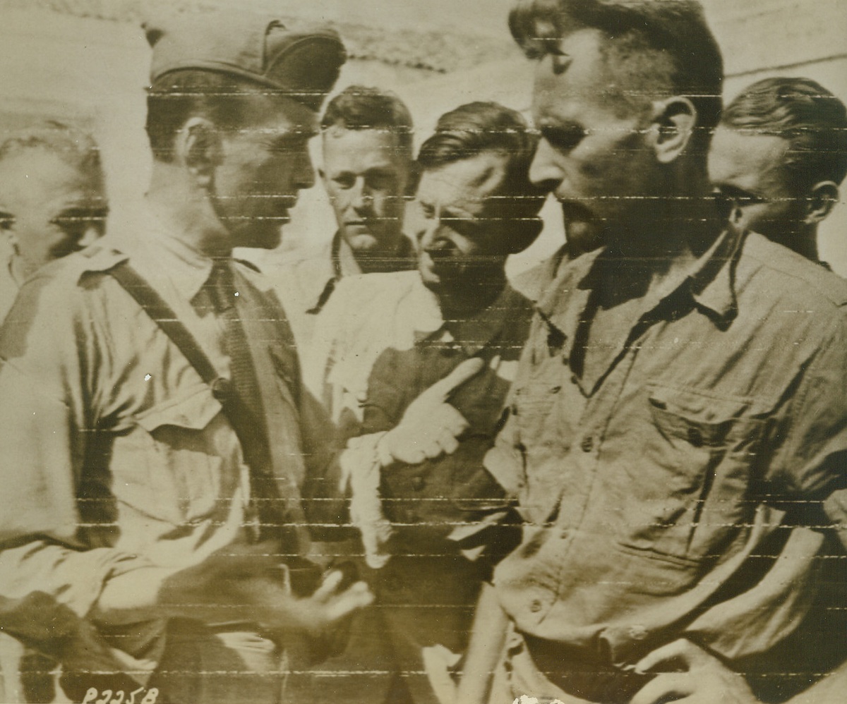 Turnabout, 10/6/1943. Major Luigo Ottino, (left), of the Italian Army, who led the capture of 11 German officers and 422 troops on the Island of Corfu, talks with one of his prisoners, in this photo transmitted to the U.S. by Radiotelephoto. The Major, working with the Allies, directed the transportation of the prisoners across the Adriatic, where they were dispatched to Allied prison camps. This was the first case where Germans on the Italian front were captured by their former partners-in-arms—the Italians.Credit Line (U.S. Signal Corps Radiotelephoto from ACME);