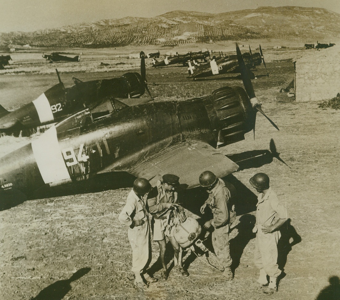 Italian War-birds Join Allies, 10/14/1943. Their performance poor on the losing side, these speedy Italian fighters and their crews wait the opportunity of fighting against the Nazis. The Italians appeared after the peace had been signed. Some were ordered to Sicily by the Badoglio government, and others came in on their own. An Italian flier talks with American soldiers just after landing.Credit (ACME from OWI);