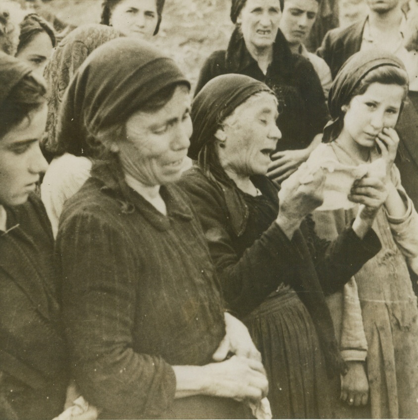 Tell Tale of Nazi Horror, 10/20/1943. RIONERO, ITALY – Grief-stricken Italian women of Rionero, Italy, sob out the story of execution of 16 men by retreating Nazis after a native farmer had shot a German chicken thief. They are unburdening their tale of woe to Canadian soldiers who entered the town.Credit Line (Acme);