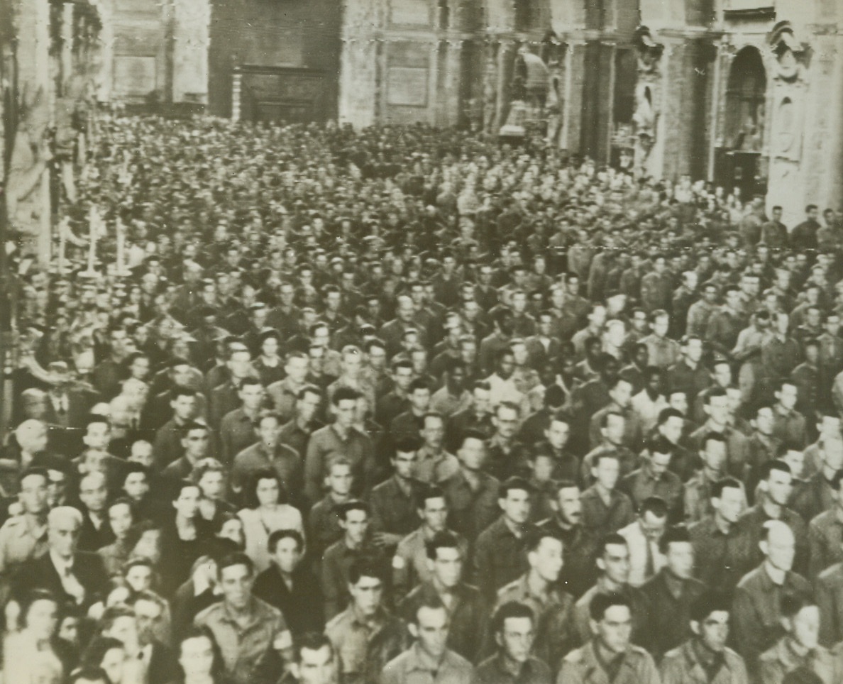 THANKSGIVING MASS IN NAPLES, 10/21/1943. This photo, flashed to the United States by radiotelephoto, shows a solemn mass of thanksgiving conducted in the Cathedral of Naples by Allied 5th Army Chaplains, for the armed forces that delivered the city. His Eminence, Cardinal Ascalesi was present in the Sanctuary during the ceremony. Many of the natives of Naples also attended. Credit: Acme photo by Charles Seawood for the War Picture Pool via Army radiotelephoto;