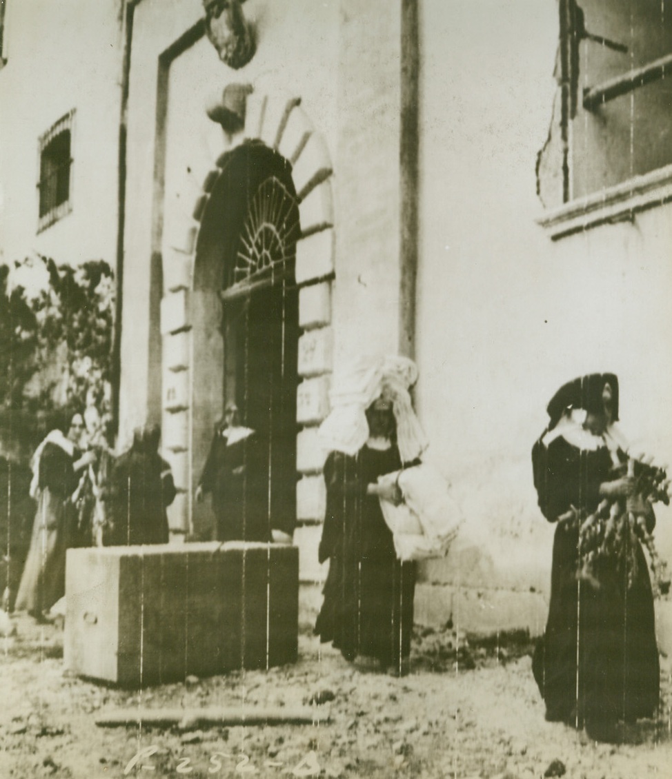 REMOVING RELIGIOUS ARTICLES FROM WRECKAGE, 10/23/1943. These nuns are shown removing religious articles from a church in Faicchio, Italy, which was badly damaged by artillery fire while Allies were taking town from Germans. Credit: Signal Corps radiotelephoto from Acme;