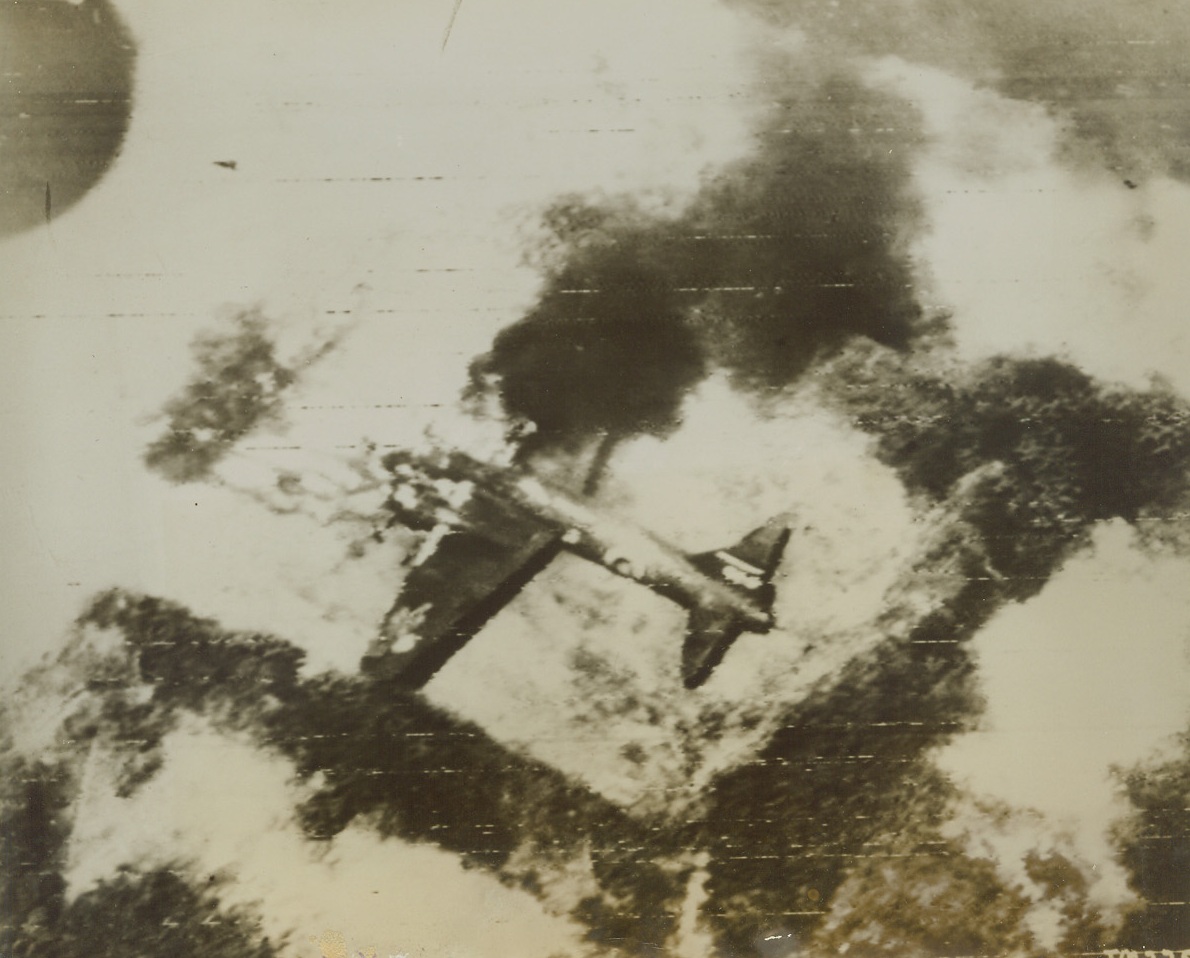 A Jap is “Scratched” at Rabaul, 10/14/1943. A Japanese Bomber in its revetment on the airfield at Rabaul, burns fiercely after it was hit by a bomb from Allied Air Raiders during this week’s devastating raid on the Nip’s powerful New Britain base. MacArthur’s airmen caught most of the Nip planes on the ground, destroying 177 of them – or about 60% of the air strength located there. Credit: U.S. Army Air Forces photo via Radiotelephoto from ACME;