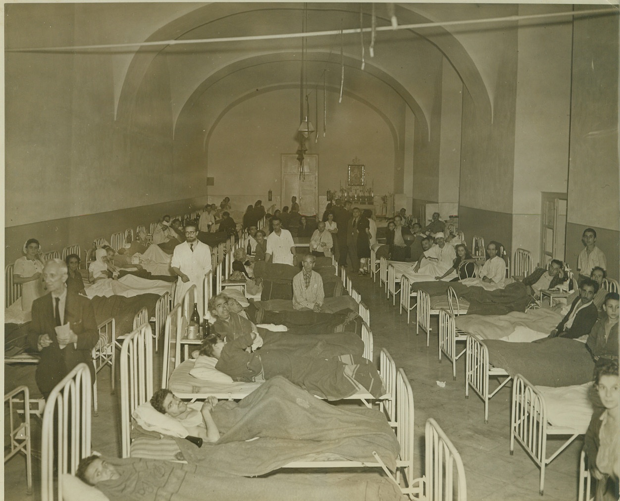 Civilians Who Fought Against Nazis, 10/9/1943. NAPLES, ITALY -- Wounded civilians crowd a ward at the Incurabilli Hospital, Naples, after the seven days civil war against the Nazis in that city. This one hospital held approximately 200 dead and 600 wounded following the bloody street war fare.  Credit: (ACME Photo by Charles Seawood, War Pool Correspondent);
