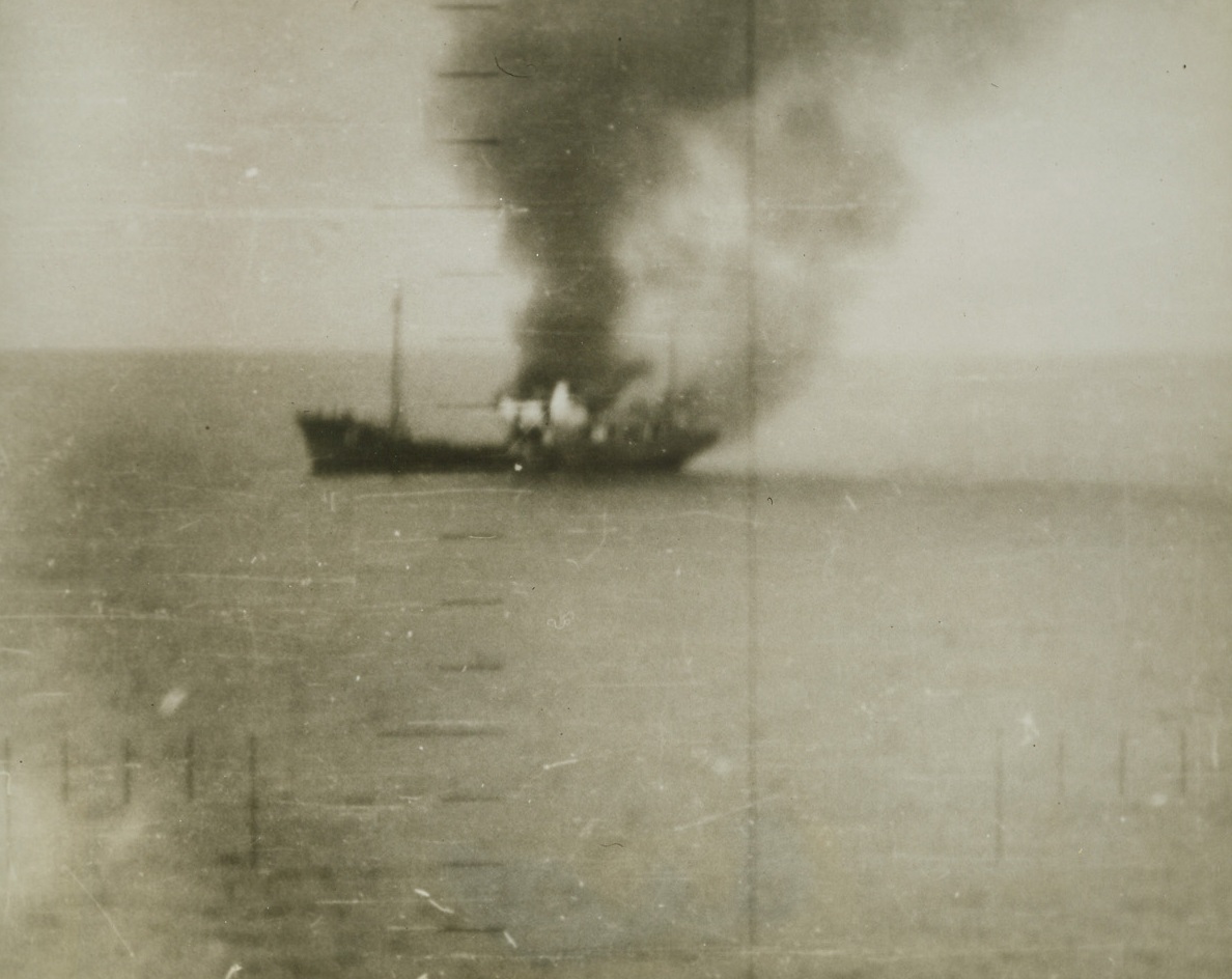 Japs  Sampan Burns After Hit, 10/19/1943. Washington, D.C. – Taken through periscope sights, this picture shows flames shooting upwards from a Japanese cargo sampan after the submarine Hal scored a hit on the boat.  Navy underseas raiders have taken a heavy toll of enemy cargo and supply ships running between Japan and her conquered territories.Credit (Off. U.S. Navy photo from ACME);