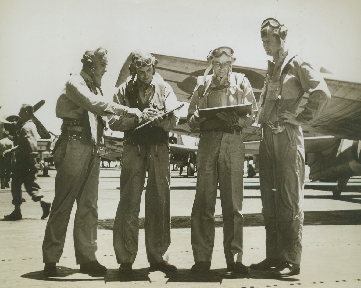 Getting Ready for Tarawa Raid, 10/16/1943. At Sea – Navy air group commanders and squadron commanders get together on the flight deck of their flat-top before taking off on the raid of Tarawa, Jap-held island of the Gilbert group, on Sept. 18 and 19.  Planning the teamwork are (left to right) Lt. Cmdr. R.H. Isely, Lt. Comdr. E.M. Snowden, Air group Commander L.B. Southerland, and Lt. Comdr. P.D. Bruie.Credit Line (official US Navy photo from ACME);