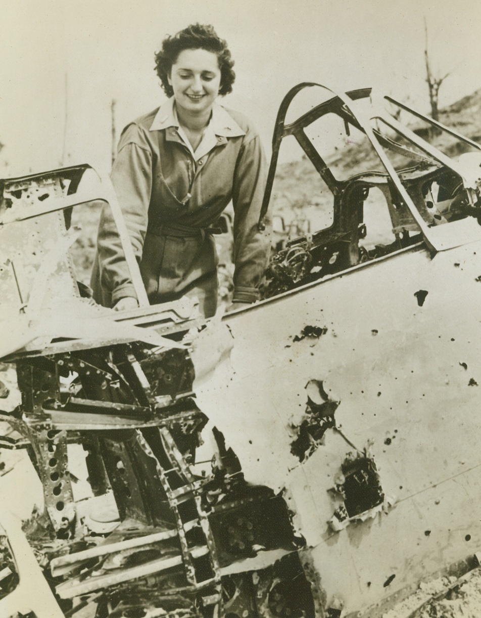 First American Woman on Munda, 10/9/1943. Munda, New Georgia—Inspecting a wrecked Jap dive bomber on captured Munda airfield, Lt. Dorothy Shiposki of Greenlake, Wisc., was the first American woman to set foot on Munda. An Army nurse, she arrived by a Marine-operated hospital plane, to help in the evacuation of wounded from the island’s fighting lines. Credit: U.S. Marine Corps photo from ACME.;