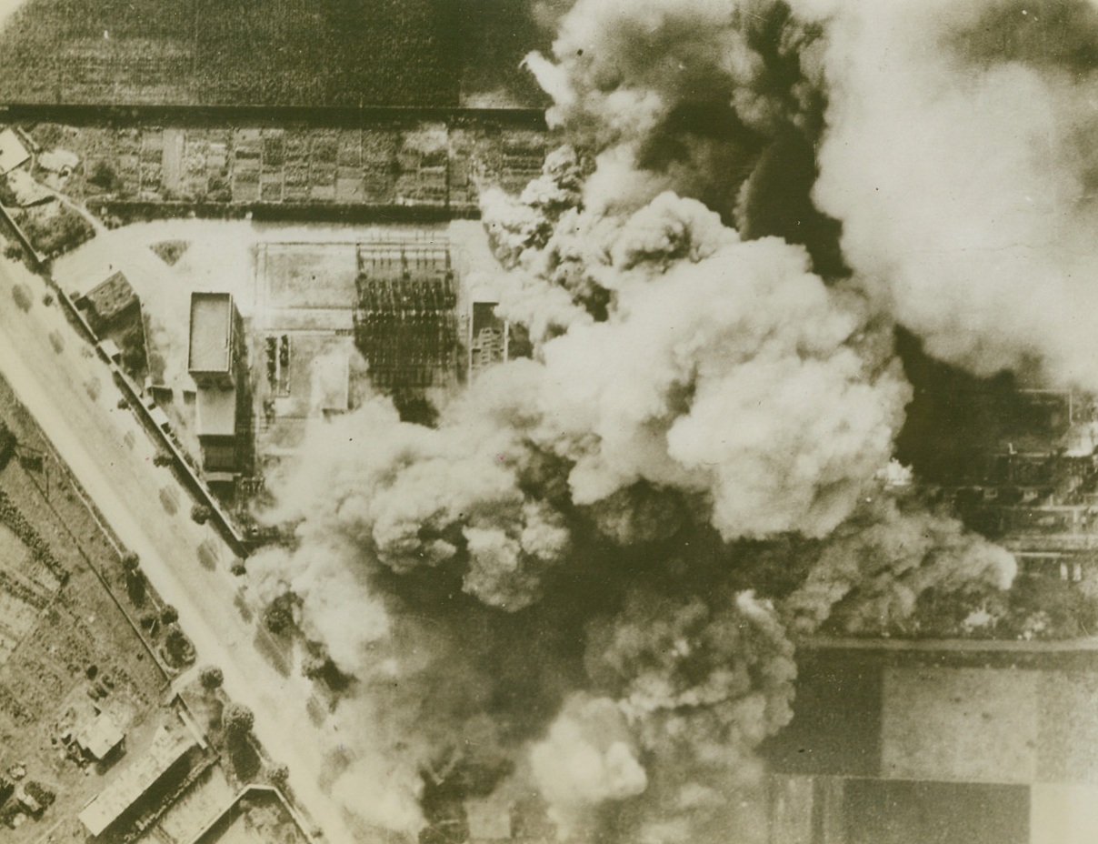 Paris Switching Station Bombed, 10/22/1943. Paris – This photo shows attack by RAF Boston Home-Light Bombers on the Chevilly-Larue Switching Station near Paris on Oct. 3rd. A great volume of smoke arises from the section of the station in which are located 220 K.V. busbars and isolating switches, walled cells containing transformers and a large building housing offices, control rooms and compensating apparatus. Credit: ACME;