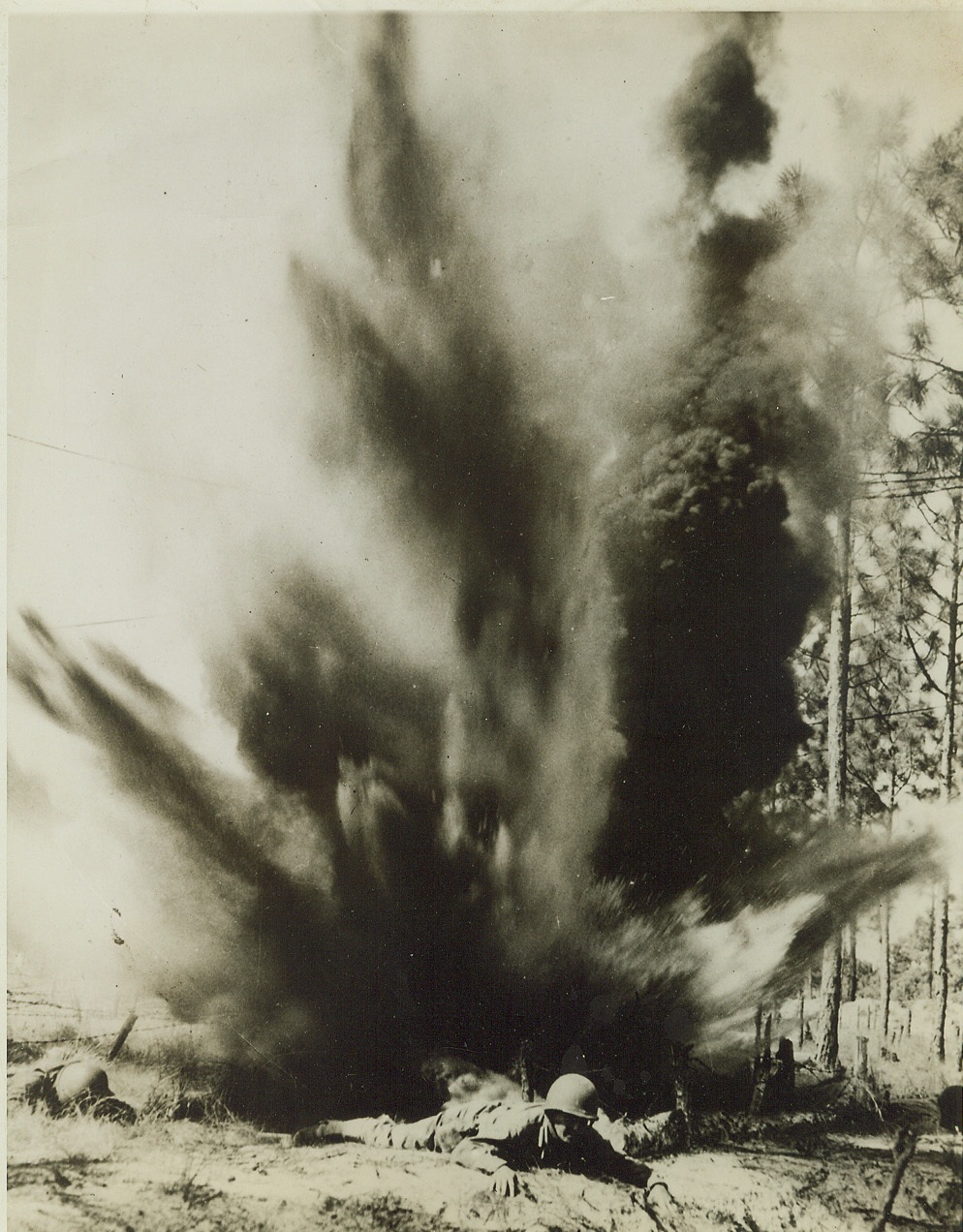 Dress Rehearsal for War, 10/14/1943. CAMP DAVIS, N.C. – This isn’t the real business, but it’s uncomfortably close to it. Officer candidates at the Antiaircraft Artillery School at Camp Davis, N.C. hug the good earth just after an explosive is set off on the combat conditioning course. Your credit: must read “ACME”;