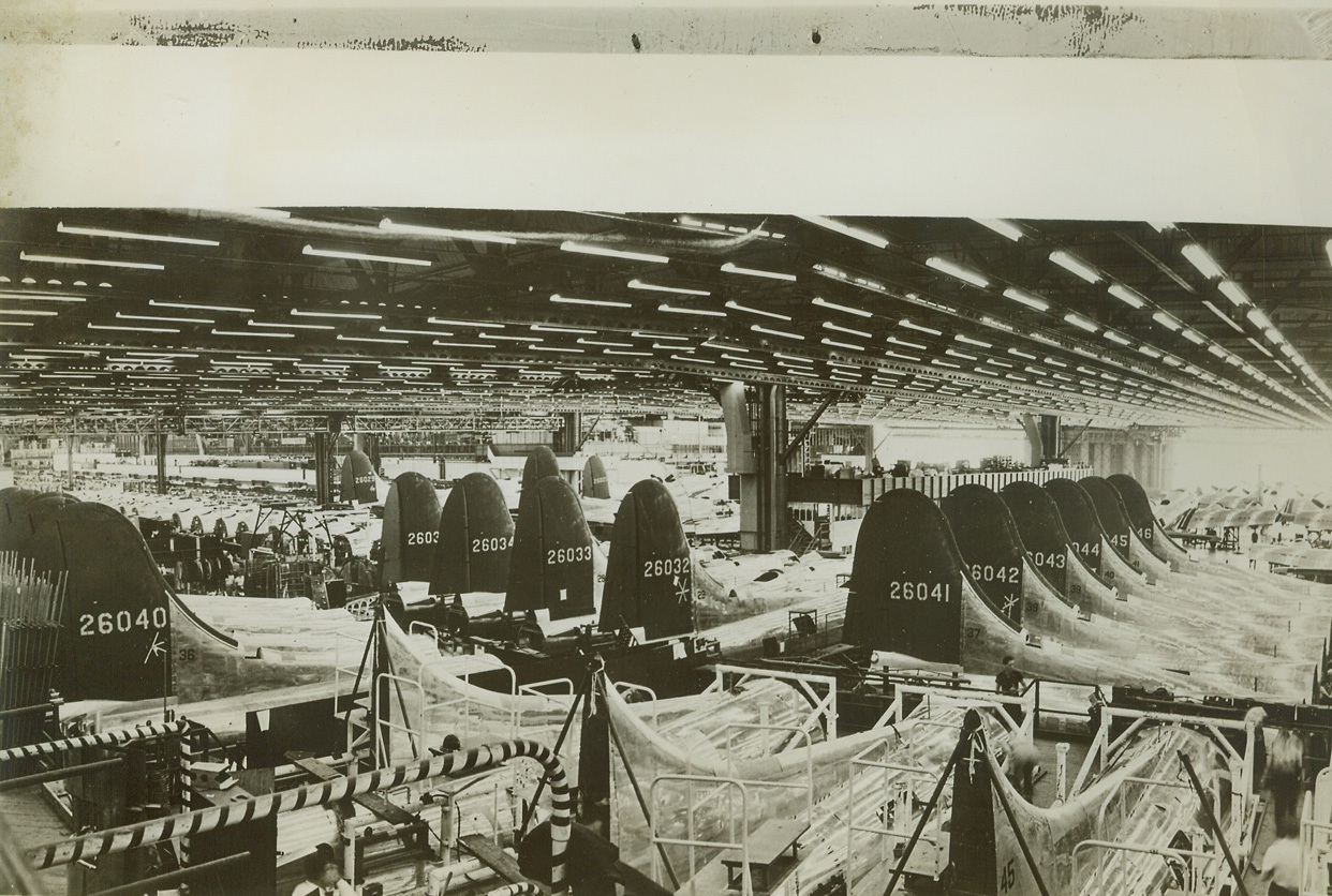 Future Air Power, 10/11/1943. Burbank, Calif.—The full impact of mass production is seen in this view at Vega Aircraft Corporation’s main plant at Burbank, where four times as many B-17 bombers are now being turned out than were built last January. Every one of these planes represents a single future headache for the Axis.  Credit: ACME;