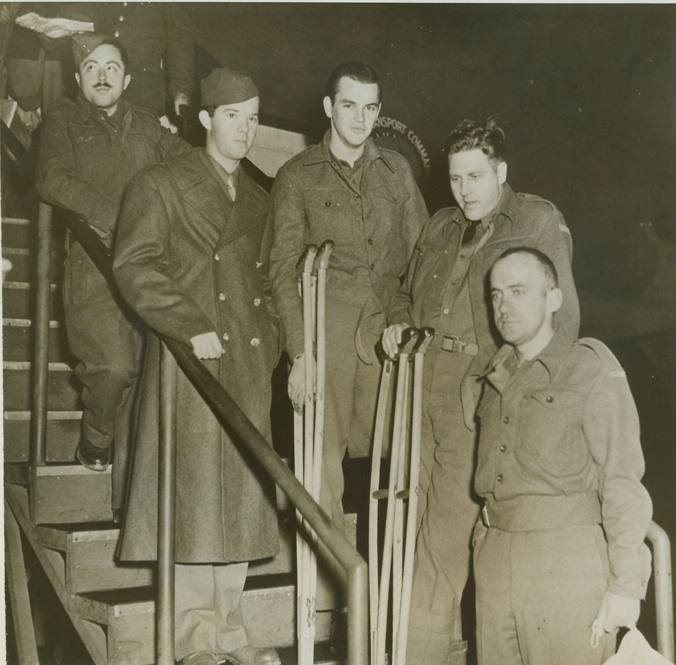 FIRST AMERICAN WOUNDED REPATRIATED FROM GERMANY, 11/3/1943. WASHINGTON, D.C. – Fourteen wounded American soldiers, the first to be repatriated from Germany under an agreement for the exchange of sick and wounded prisoners, arrived by plane at the National Airport and were immediately transferred to Walter Reed Hospital. At the airport on arrival are (left to right) T/Sgt. Frank J. Bartnicki, Baltimore, MD.; S/Sgt. Milton K. Williams, St. Louis, MO., S/Sgt. Norman C. Goodwin, Bradford, Mass.; T/Sgt. John H. Garder, Yoakum, Tex.; and S/Sgt. Lester F. Miller, Hartford, Conn. Credit: U.S. Army photo via OWI Radiophoto from ACME;