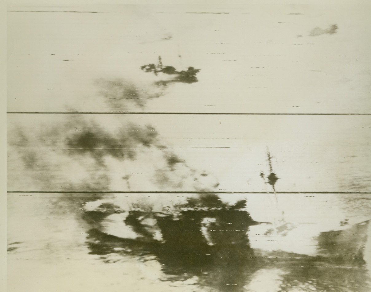 RABAUL BLASTED AGAIN, 11/4/1943. Two Jap cargo vessels blaze furiously in Rabaul Harbor after American airmen smashed at the powerful Nip New Britain base, recently, in one of a series of raids which are neutralizing Jap power in the area. Last Tuesday, the Yank fliers struck the Rabaul base again, damaging or destroying 26 ships, including five warships, and blasting 108 planes. Our losses were 19 planes.  Credit: U.S. Signal Corps radiotelephoto from ACME;