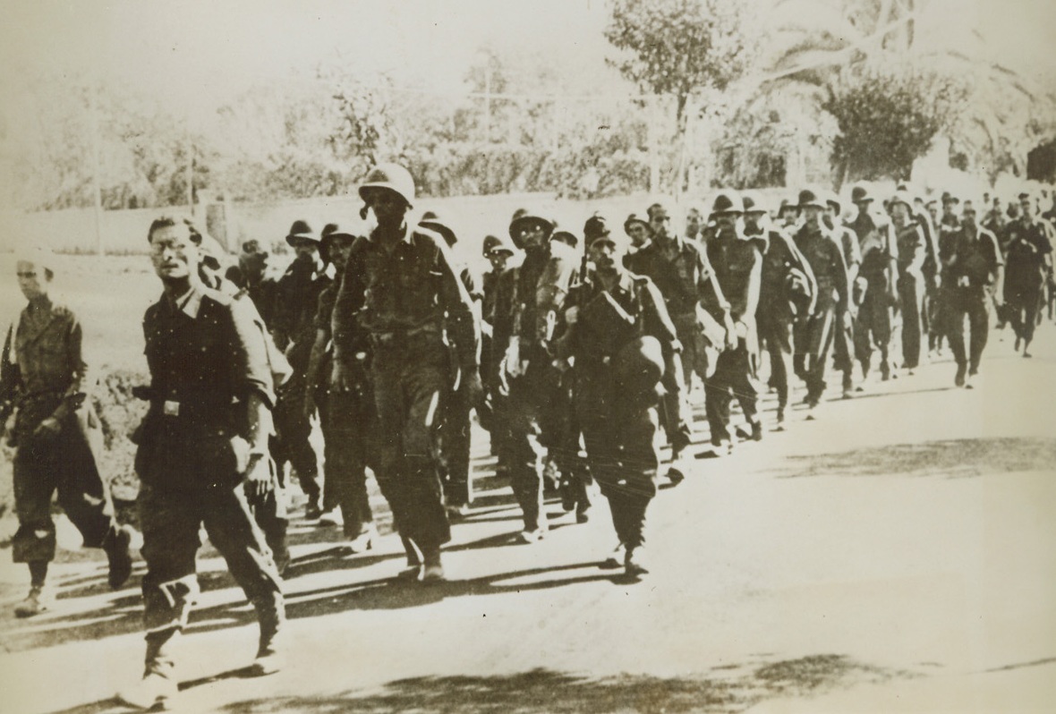 Yanks Seized by Nazis, 11/7/1943. The Germans describe this long column of soldiers as American prisoners of war, captured in Italy. The caption accompanying the photo, received in Lisbon, says the Yanks are being marched off to prison camp.Credit Line (ACME);