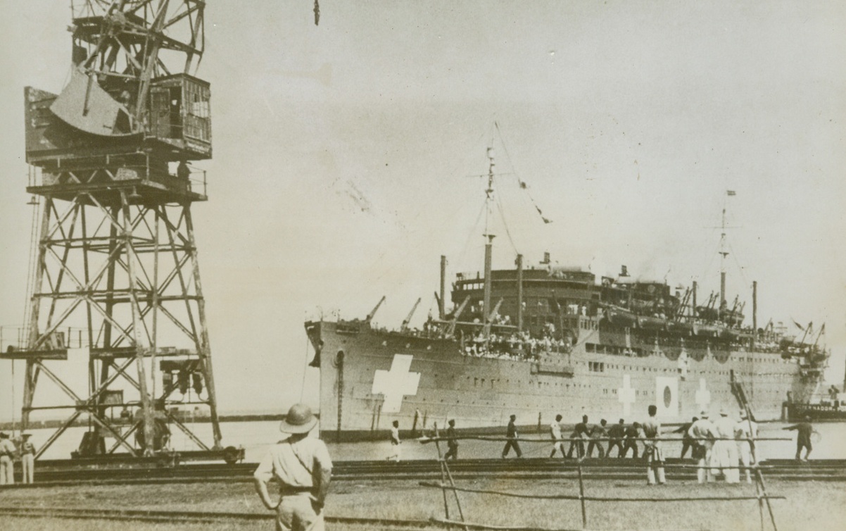 1,500 ALLIES ON THE WAY HOME, 11/1/1943. MORMUGOA, PORTUGUESE INDIA—The Japanese exchange ship, Teta Maru, docks at the port of Mormugoa, Portuguese India, with 1,500 Allied internees, including 1,100 American nationals on board. The former prisoners line the rails for a glimpse of the land which represents the beginning of freedom. Credit: Acme;