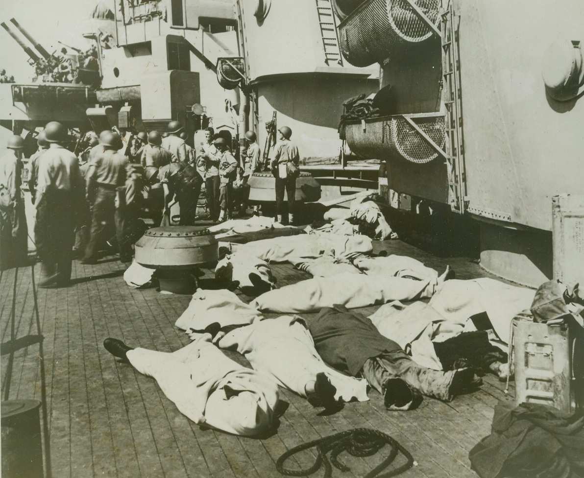 KILLED ON SAVANNAH, 11/2/1943. SALERNO, ITALY—Clean blankets cover the bodies of crew members who died when a Nazi bomb blasted a gun turret on the Savannah during the invasion at Salerno, September 11. Other American fighters continue to carry out the covering of the landings of American forces, as the fire resulting from the explosion is brought under control within 20 minutes. Credit: Official U.S. Navy photo from Acme;