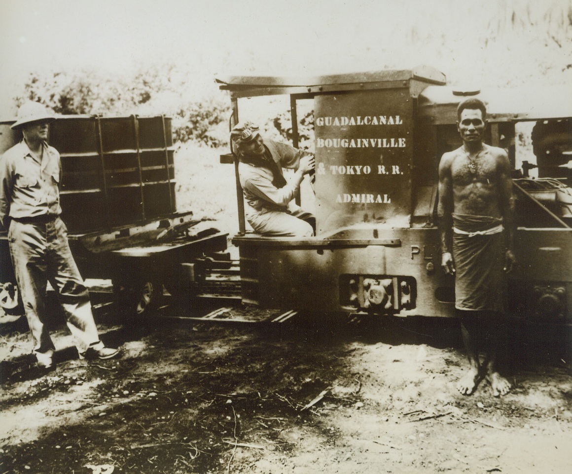 MODERN “OLD 97”, 11/3/1943. SOUTH PACIFIC—Although it has only one engine, the G.B.&T. railroad does just about as much work for its size as some of its larger brothers. The Guadalcanal, Bougainville & Tokyo R.R. is a narrow gauge line at an Allied South Pacific base which hauls supplies from the harbor to a supply base. Here, (photo above) the engineer of the “Admiral”, the line’s lone locomotive, “opens her up” for a long pull—not to Tokyo yet, but it won’t be long! Credit: U.S. Navy photo from Acme;