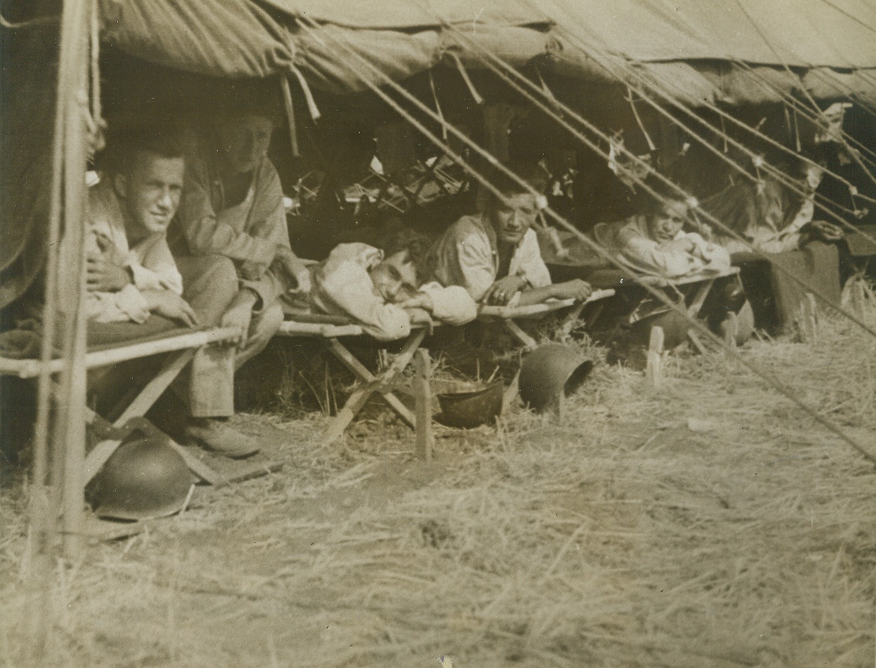 Recovering in Italy, 11/18/1943. Italy – These patients ill or slightly wounded, at an evacuation hospital in Italy, who are anxious to get back to their fighting units, are, (left to right): Pvt. John Banasiak, of Brooklyn, N.Y. (177-23rd St.); Pvt. Eugene Phillips, Bronx, N.Y.; Cpl. Stanley Woodward, Glasgow, KY.; S/Sgt. Manuel Reza, El Paso, Tex. (3016 Frudas St.); Cpl. Irving R. Nuttall, Philadelphia, PA. (6103 Torresdale, Ave.); Pvt. Dick Acker, Medford, Mass.; and Cpl. John Ausewein, Secaucus, N.J. Credit: U.S. Signal Corps photo from ACME;