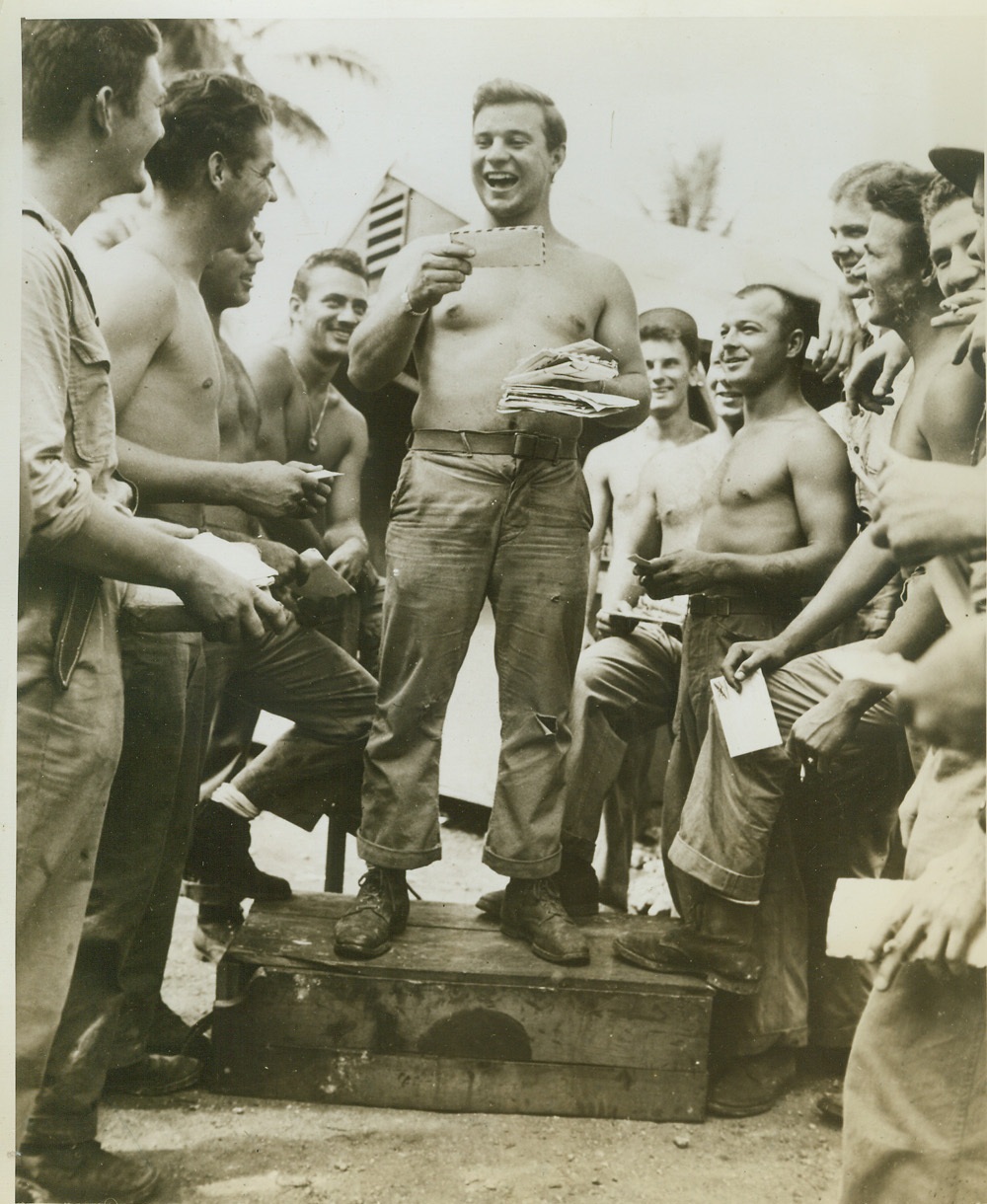 Mail Ho!, 11/16/1943.  SOUTH PACIFIC -- There's nothing to give a fighting man a new lease on life, the way the "mail call" does. The smiles on the faces of these Marine fliers on Espiritu Santo, reflect the holiday spirit which prevails when a buddy sings out names of the addresses on the letter. (Let's have that "sugar report" bub!) Credit: (U.S. Navy Official Photo from ACME);