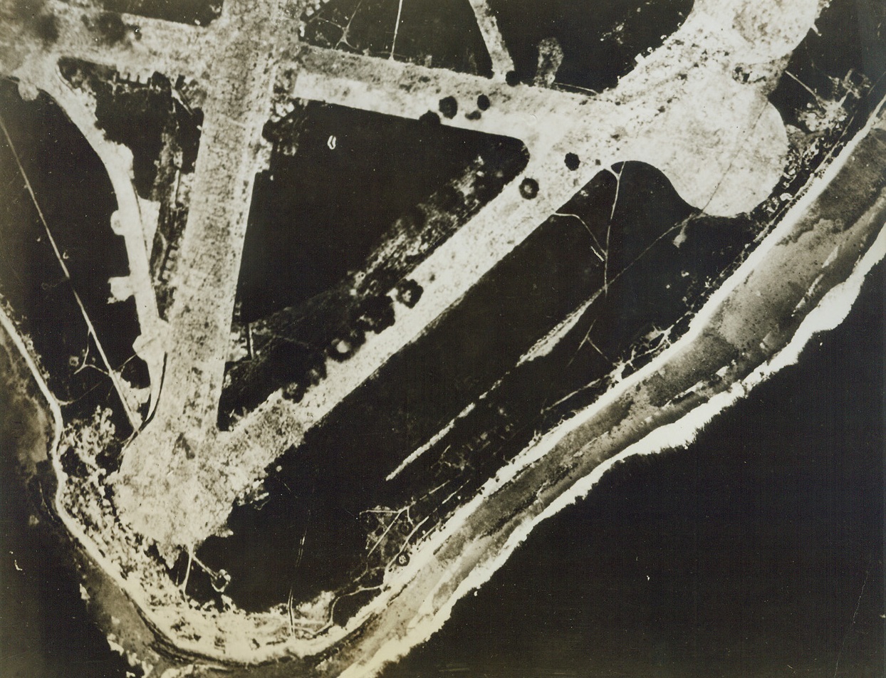 Would Atoll Call be Coming?, 11/30/1943. Mille, M.I.: Shown here is Mille Atoll, in the Marshall Islands, which may be the enemy base next on the American invasion schedule in the Central Pacific. Bomb hits can be seen, registered by American Liberators, on the Jap’s triangular runways. Attack here by the Seventh Air Force preceded the Pacific Fleet’s assault on the Gilbert group. Credit: Official U.S. Army Air Force photo from ACME;