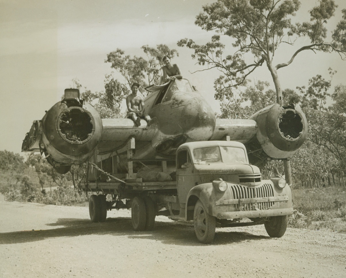 Aircraft Carrier, 11/25/1943. Somewhere In Northwest Australia – Returning to its base in Northwestern Australia on one motor, and making a belly landing, this royal Australian Air Force Beaufighter completed a successful mission in Timor.  Now, riding atop an aircraft-carrier-on-wheels, the warbird is heading for a repair shop for reconditioning.  It will soon fight from the skies again, with the Beaufighter Squadron that has rung up a total of 60 destroyed enemy aircraft, 4 probables, and 61 damaged, in the first ten months of 1943.Credit Line – WP—(Photo by Thomas L. Shafer, ACME Correspondent for War Picture Pool);