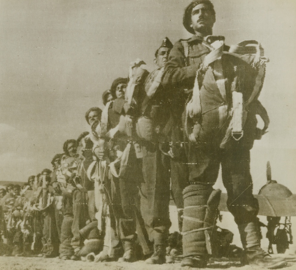On Samos They’ll “Do or Die”, 11/15/1943. Middle East – Greek parachutists of the famous Sacred Brigade prepare to put their 2,000-year-old slogan, “Come Back Victorious or Dead”, into effect on Samos Island, as they board the R.A.F. transport which dropped them over the Dodecanese Island.  The Greeks were trained as paratroopers following the Tunisian campaign.Credit (ACME radio photo);