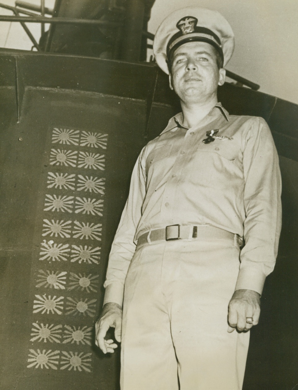 His Specialty is Knocking Out Jap Ships, 11/10/1943. At a Pacific base – Lt. Comdr. Roy M. Davenport (above) of Los Angeles, Calif., wears the Navy cross recently presented to him for sinking “many thousands of tons” of enemy shipping.  Davenport, a submarine commander, stands beside his vessel’s conning tower, on which are painted Jap flags indicating the enemy victims.Credit Line (Official US Navy photo from ACME);
