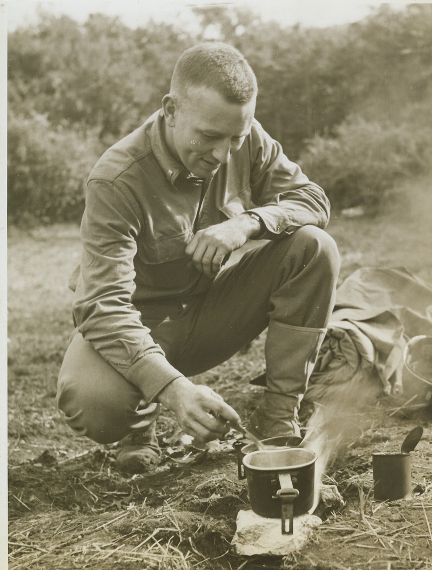 But It's No Picnic, 11/8/1943. ITALY - This may remind you of the days you've been out picnicking in the nice peaceful countryside, but to Lt. Rupert Prohme, Burlingame, Calif., member of a U.S. Infantry regiment, it's a lot different. Taking advantage of a brief half-hour lull in fighting near Pietravairano, Italy, he heats C rations and hot chocolate over an open fire as he prepares his lunch. Credit: -- WP--(ACME Photo by Bert Brandt War Pool Photographer);