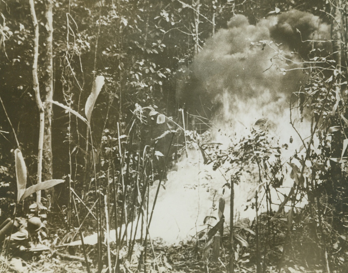 Smoking the Japs Out, 11/24/1943. New Georgia Island – Firmly entrenched in the jungles of New Georgia, the Japs, had to be literally smoked and burned out of their positions.  Here, flame from a U.S. infantryman’s flame thrower sprays a Jap pillbox during mopping-up operations.Credit Line (U.S. Signal Corps photo from ACME);
