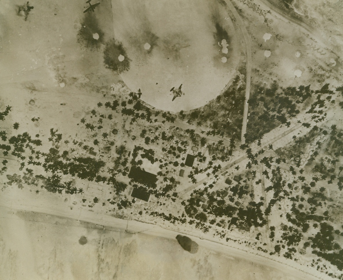 U.S. Troops Land on Tarawa, 11/21/1943. New York – Marines and Army troops, covered by forces of all types, established beachheads against moderate resistance at Makin island and strong resistance at Tarawa Island, according to a radio broadcast from Honolulu today.  Above photo shows Army bombers blasting the Jap airfield at Tarawa, which is not very far from the large Jap naval base at Truk.  Landings on the two Gilbert islands started Friday afternoon;