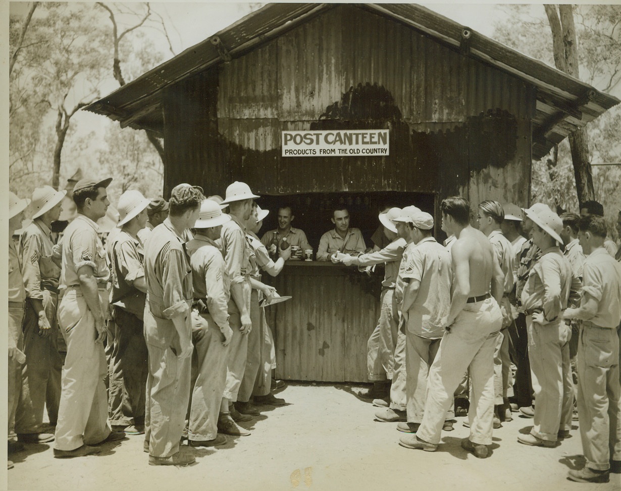 Afternoon Tea in Australia, 11/22/1943. AUSTRALIA -- This B24 Liberator Service Squadron's Post Office and Canteen is always one of the most popular places in Fenton, Australia. At the canteen counter are Sgt. Carroll Smith, of Fort Worth, Texas, canteen steward, and 2nd Lt. Melvin Freeman, of Chickasha, Okla., who is canteen officer. Credit: (ACME Photo by Thomas L. Shafer, War Pool Correspondent);