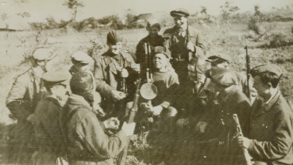 Nazi Haters, 11/16/1943. A group of Nazi-hating Ukranian partisans, who made life miserable for Hitler’s men before the Red Army entered the Ukraine to finish the job, halt in a field for a well-earned rest. Holding their weapons, they sit in a circle and chat before taking up the battle with the foe again. Credit: ACME radiophoto.;