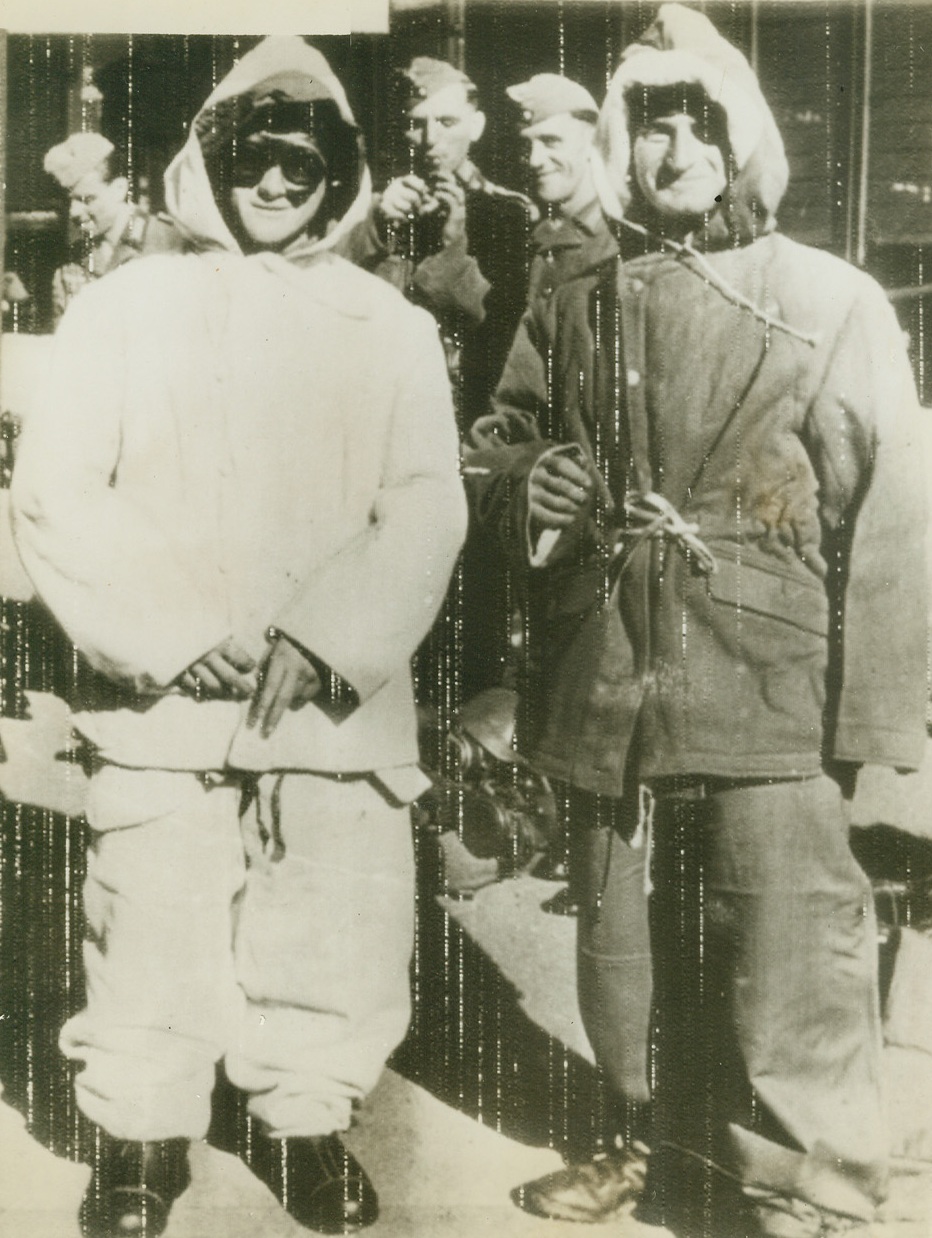 All-Purpose Nazi Uniform, 11/1/1943. Russia—Photo radioed this morning from Stockholm shows two Nazi soldiers posing in new winter uniform which German caption said was designed from experience of past two winters in Russia. It is reversible—one side white for snowy territory and the other brown for muddy ground—which is claimed good camouflage. Bulky uniform, besides being warm, might also have been designed to stop Nazi army from running away so fast. Credit: ACME radiophoto.;