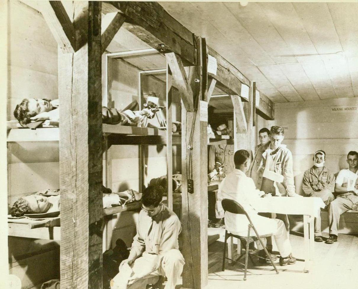 Underground ward, 11/19/1943. CAMP ROBINSON, ARK. – Here is a view of one of the wards of a 3-ward underground hospital that has been carved out of sandstone and solid rock at Camp Robinson. Complete with X-ray equipment and operating facilities, the hospital can be built in the field, under combat conditions, in 24 hours. Simulated casualties are shown undergoing treatment in the hospital. CREDIT LINE (Official U.S. Army photo from ACME) 11-19-43;