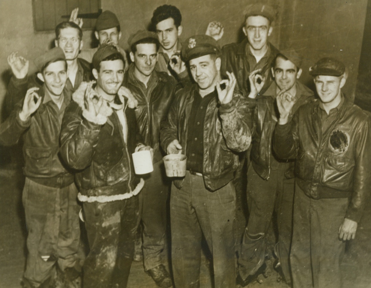 AFTER THEIR 25TH MISSION, 11/16/1943. ENGLAND – The Eight Air Force’s huge daylight raid on Wilhelmshaven marked their 25th raid over Europe for these ten flying Yanks, who are shown celebrating their safe return.  In front (left to right) are two pilots: Captain Sam P. Satariano of Modesto, Calif.; and Lt. Lester L. Barnard of Donna, Texas.  Grouped around the officers are (left to right): T/Sgt. Robert F. Bryson, Stockport, Iowa; Sgt. D.D. Perry, Aberdeen, S.D.; S/Sgt. H.A. Richmond, Fenimore, Wisc.: T/Sgt. George J. Gabriel, Auburn, NY; T/Sgt. H.E. Forrest, Athol, Mass.; S/Sgt. John H. Roth, Jr., Mt. Joy, Pa.; S/Sgt. Phern Stout, Lockwood, Mo.; and S/Sgt. Robert M. Dawson, Detroit, Mich.Credit: Acme;