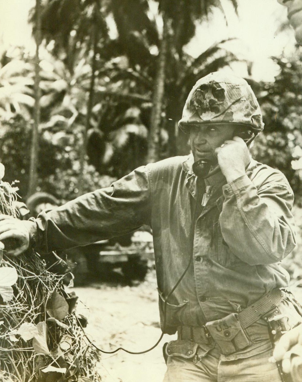 Texan Giving Japs A Bad Time, 11/19/1943. Bougainville, S.I., -- Marine Lt. Col. Fred D. Beans (above), of Cleburn, Tex. keeps his eyes peeled for Japs as he stands at a field telephone directing an artillery barrage on Bougainville Island.  11/19/43 (ACME);
