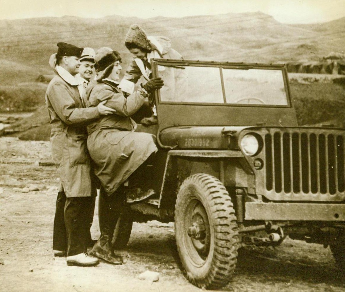 Modern Version Of The "Buggy Ride", 11/11/1943. Adak, Alaska -- Laughing gaily, two Navy nurses are helped aboard a jeep for a sightseeing trip around the Aleutian base. They are: Ensign Margaret Allen, of Denver, Colo., and Ensign Mary Louise Eckes, (right), of San Francisco, Calif., And Dickinson, N.D. The two U.S. Navy officers will act as hosts on the trip. (ACME);