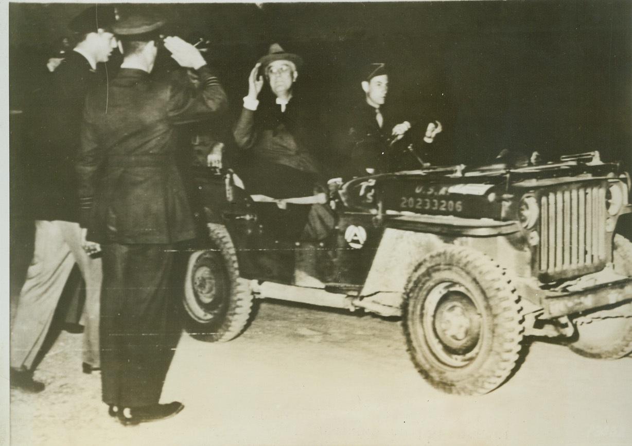FAMOUS FATHER MEETS FIGHTING SON, 12/4/1943. NORTH AFRICA – As he returns an RAF officer’s salute, President Roosevelt has eyes only for his son, Col. Elliot Roosevelt, (left) Commanding Officer of a reconnaissance unit, who greets the American Chief Executive at an airfield in North Africa. Driver of the Presidential jeep is Cpl. Arthur S. Rice, of Greensburg, MO who also had Gen. Eisenhower and Lt. Gen. Carl Spaatz as passengers. The RAF officer is Wing Comdr. Eric L. Fuller, Deputy Commander of a photo unit. Credit: Signal Corps photo via OWI Radiophoto from ACME;