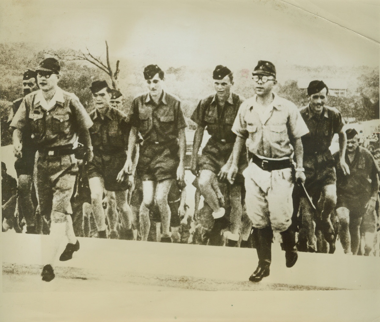 ”SUPERMEN” OF THE EAST AND WEST, 12/13/1943. SINGAPORE – Two Japanese officers lead a party of German soldiers on a sight-seeing tour of the great Jap naval base at Singapore. Base is under the command of General Yamashita and a number of Nazi soldiers are stationed there, forming part of the garrison at the former British “Gibraltar of the East.” Credit: ACME;