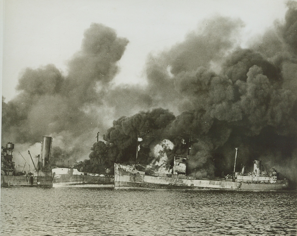 Axis Attack on Bari, 12/16/1943. Allied ships burn furiously in the Southern Italian port of Bari following a German air raid on Dec. 2, 1943. Secretary of War Stimson today announced that two ammunitions ships were hit, and the resultant explosion caused spreading fires which destroyed or damaged a number of Allied cargo ships and small harbor craft. There were an estimated 1,000 casualties, including 37 American naval personnel. U.S. Army Signal Corps Photo From (ACME);