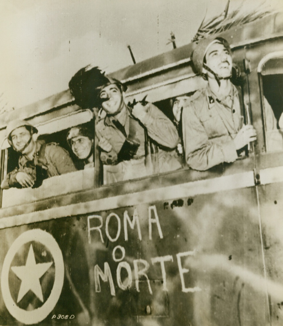 No Excursion, This, 12/ 11/1943. Italy—Italian soldiers are living up to the “Rome or Death” slogan lettered on their vehicle which travels to the front. Fighting alongside British and American troops, they hate the Germans as strongly as the Allies and with good reason, for an Italian general reports that the Nazis kill all the native soldiers they capture, calling them traitors. Credit: Signal Corps radiotelephoto from ACME.;